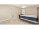 Bright bedroom featuring Saltillo tile flooring, a fan, and access to a bathroom at 6025 N 10Th Pl, Phoenix, AZ 85014