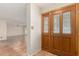 Inviting foyer features striking paneled wood door, decorative glass and neutral walls and tile floors at 6025 N 10Th Pl, Phoenix, AZ 85014