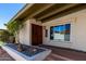 Front door and entry featuring house number and manicured landscaping at 6025 N 10Th Pl, Phoenix, AZ 85014