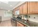 Cozy kitchen features wood cabinets, stainless steel oven range, and a sunny window at 6025 N 10Th Pl, Phoenix, AZ 85014