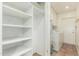 Functional laundry room with washer, dryer, storage shelves, and access to the outside at 6025 N 10Th Pl, Phoenix, AZ 85014