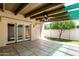 Covered patio with tile flooring, fan, and views of the landscaped backyard and lawn at 6025 N 10Th Pl, Phoenix, AZ 85014
