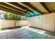 A covered patio with a ceiling fan, tiled floor, and access to a green backyard at 6025 N 10Th Pl, Phoenix, AZ 85014