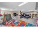 Spacious finished basement with colorful play area and comfortable seating area at 6708 W Utopia Rd, Glendale, AZ 85308