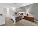 Cozy bedroom featuring soft lighting, neutral walls and carpet, and closet at 6708 W Utopia Rd, Glendale, AZ 85308