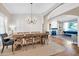 Spacious dining room with hardwood floors, large table, and a chandelier at 6708 W Utopia Rd, Glendale, AZ 85308