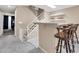 Inviting entryway with tiled floors, staircase with baby gate, and bar counter with two stools at 6708 W Utopia Rd, Glendale, AZ 85308