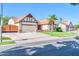 Well-maintained single-Gathering home featuring a two-car garage, brick accents, and neat landscaping at 6708 W Utopia Rd, Glendale, AZ 85308