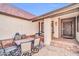 Inviting front porch area with outdoor seating, a rug, and a view of the entrance at 6708 W Utopia Rd, Glendale, AZ 85308