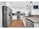 Modern kitchen with stainless steel appliances, granite countertops, and white cabinets at 6708 W Utopia Rd, Glendale, AZ 85308