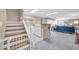 Open living space featuring a small kitchenette, staircase, and a comfortable recreation room for entertainment at 6708 W Utopia Rd, Glendale, AZ 85308
