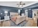Comfortable main bedroom with blue accent wall, plush bed, and side tables with lamps at 6708 W Utopia Rd, Glendale, AZ 85308