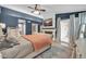 Main bedroom with a fireplace, TV, and balcony access offering natural light at 6708 W Utopia Rd, Glendale, AZ 85308