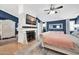 Main bedroom with a cozy fireplace, TV, and ensuite bathroom with an elegant design at 6708 W Utopia Rd, Glendale, AZ 85308
