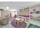 Spacious playroom featuring built-in shelving, colorful rugs, and a variety of toys for endless fun at 6708 W Utopia Rd, Glendale, AZ 85308