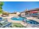 Inviting backyard featuring a pool, spa, lounge area, and lush landscaping at 6708 W Utopia Rd, Glendale, AZ 85308