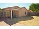 Spacious backyard with a covered patio, desert landscaping, and a secure fence, perfect for entertaining at 674 E Renegade Pl, San Tan Valley, AZ 85143