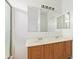Bathroom featuring double sinks, oak cabinets, large mirror, and a glass-enclosed shower at 674 E Renegade Pl, San Tan Valley, AZ 85143