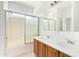 Bathroom featuring a glass shower door, double sinks, oak cabinets, and a large mirror at 674 E Renegade Pl, San Tan Valley, AZ 85143