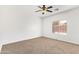 This room features a ceiling fan and a window that lets in natural light at 674 E Renegade Pl, San Tan Valley, AZ 85143