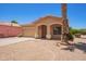 Charming single-story home featuring a desert landscape, a mature palm tree, and a two-car garage at 674 E Renegade Pl, San Tan Valley, AZ 85143