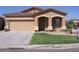 Inviting single-story home featuring a low-maintenance yard, two-car garage, and desert landscaping at 674 E Renegade Pl, San Tan Valley, AZ 85143