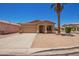 Charming single-story home with a well-maintained desert landscape and a mature palm tree at 674 E Renegade Pl, San Tan Valley, AZ 85143