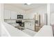 Modern kitchen featuring white cabinetry, stainless steel appliances, and a breakfast bar at 674 E Renegade Pl, San Tan Valley, AZ 85143