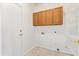Functional laundry room featuring overhead cabinets, shelving, and washer/dryer hookups at 674 E Renegade Pl, San Tan Valley, AZ 85143
