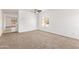 Bright living room with neutral carpet, white walls, a ceiling fan and a large window at 674 E Renegade Pl, San Tan Valley, AZ 85143