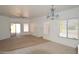 Bright and airy living room with tile and carpet flooring, neutral walls, and ample natural light at 674 E Renegade Pl, San Tan Valley, AZ 85143