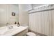 Bright bathroom with vanity, mirror, toilet, and shower with curtain at 699 S 197Th Dr, Buckeye, AZ 85326