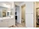 Bright bathroom featuring a glass-enclosed shower, vanity, toilet room, and walk-in closet at 699 S 197Th Dr, Buckeye, AZ 85326