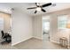 Carpeted bedroom with ceiling fan, desk, and windows for ample natural light at 699 S 197Th Dr, Buckeye, AZ 85326