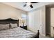 Cozy bedroom with a bed, sliding closet doors, and a ceiling fan at 699 S 197Th Dr, Buckeye, AZ 85326