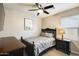Bedroom with a ceiling fan, queen bed, and dresser for storage at 699 S 197Th Dr, Buckeye, AZ 85326