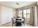 Dining area by large windows features a round table and stylish curtains, creating a cozy place for meals and gatherings at 699 S 197Th Dr, Buckeye, AZ 85326