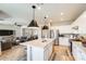 Open-concept design features a stylish island, stainless steel appliances, and seamless flow to the living and dining areas at 699 S 197Th Dr, Buckeye, AZ 85326
