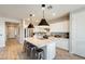 Bright kitchen featuring stainless steel appliances, a center island with barstool seating and pendant lighting at 699 S 197Th Dr, Buckeye, AZ 85326
