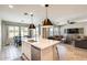 Open kitchen view showcases an island, stainless steel dishwasher, and seamless transition to the dining and living areas at 699 S 197Th Dr, Buckeye, AZ 85326