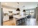 Modern kitchen boasts stainless steel appliances, a large island with seating, and stylish pendant lighting at 699 S 197Th Dr, Buckeye, AZ 85326