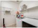 Laundry room features white appliances, shelving, and storage solutions at 699 S 197Th Dr, Buckeye, AZ 85326