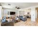 Living room showcases a modern sofa, neutral walls, tile flooring, natural light, and access to the dining area at 699 S 197Th Dr, Buckeye, AZ 85326