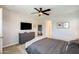 This main bedroom includes a dresser, mirror, wall-mounted TV, and large windows at 699 S 197Th Dr, Buckeye, AZ 85326