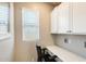 Office space with a desk, chair, upper cabinets, and natural light at 699 S 197Th Dr, Buckeye, AZ 85326