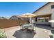 Outdoor patio area with dining set and desert landscaping, perfect for relaxing and entertaining guests at 699 S 197Th Dr, Buckeye, AZ 85326