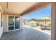 Spacious covered patio overlooking the pool area and landscaped yard, ideal for outdoor gatherings at 699 S 197Th Dr, Buckeye, AZ 85326