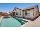 Relaxing backyard featuring a private pool, covered patio, and ample space for outdoor entertaining at 699 S 197Th Dr, Buckeye, AZ 85326