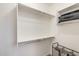 Walk-in closet featuring long shelves for storage and laundry bins at 699 S 197Th Dr, Buckeye, AZ 85326