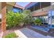 Courtyard with stone pavers, a variety of plants, privacy windows, and modern architectural details at 7151 E Rancho Vista Dr # 6002, Scottsdale, AZ 85251